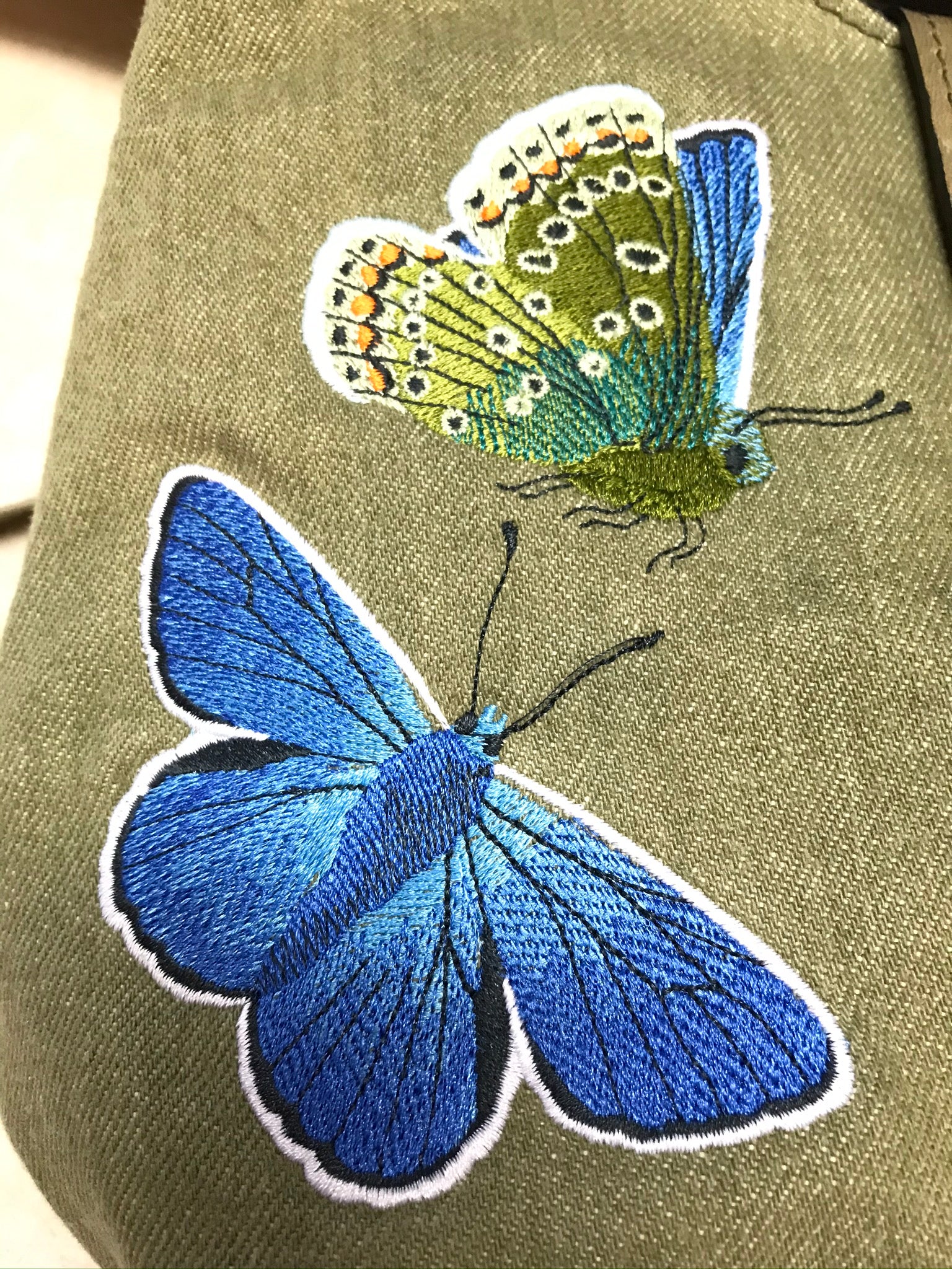Blue Butterfly on Green Denim Cottagecore Hobo embroidery close-up view